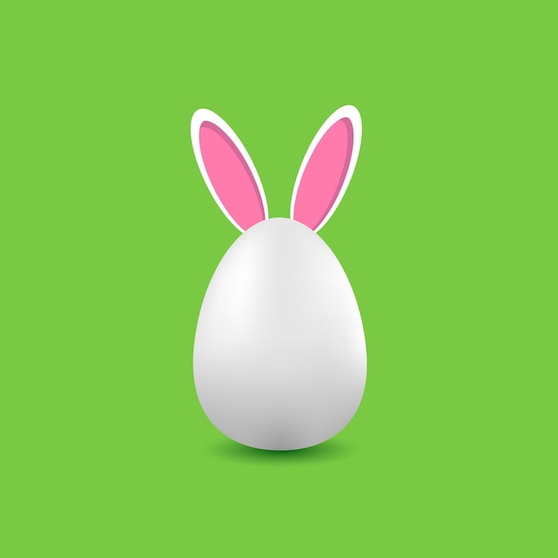 White egg with rabbit ears on a green background