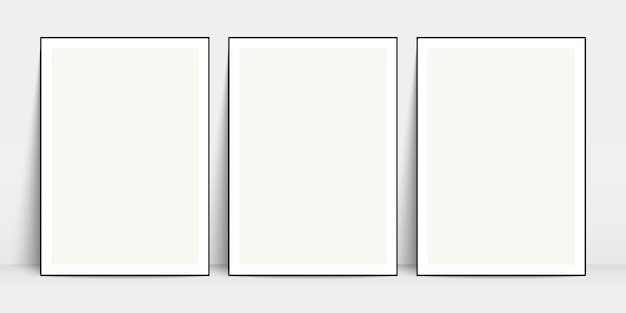 ベクトル 白い壁の近くの床に立っている黒いフレームのモックアップと白いポスター空白のキャンバスのモックアップ