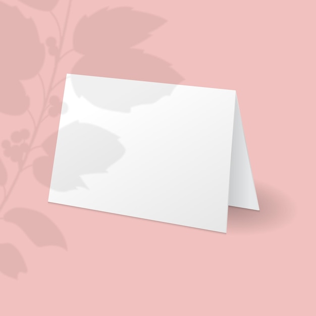 White standing card template with holly berry branch with leaves overlay shadow. 