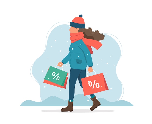 Winter sale, girl with shopping bags in winter.