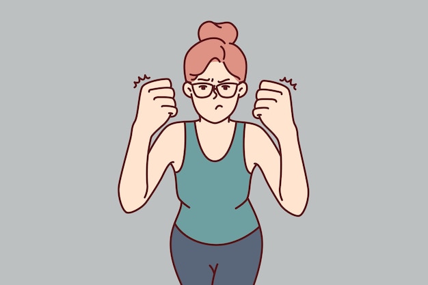 Woman clenches fists demonstrating willingness to fight and feeling desire to beat offender because of insult or aggression Strong girl in glasses looks at screen showing aggression and hatred