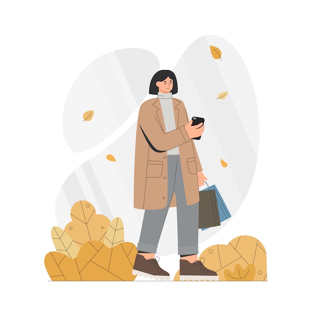 Woman in a coat holds a phone and bags in autumn.