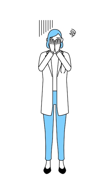 A woman doctor in white coat covering her face in depression