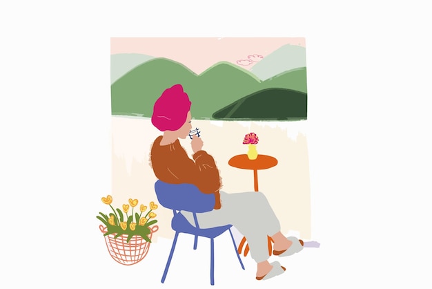 山のテラスに座ってお茶を飲む女性