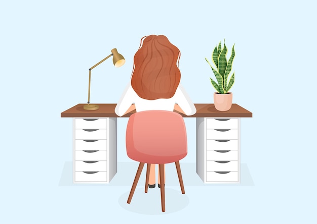 Woman freelancer or student sits at a table on an isolated background back view of the girl