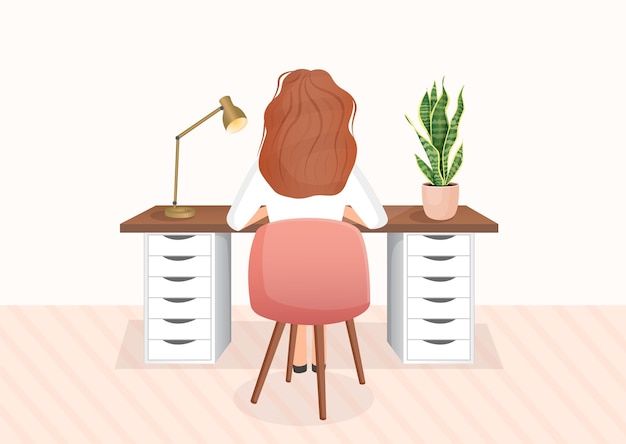 Woman freelancer or student sits at a table on an isolated background back view of the girl