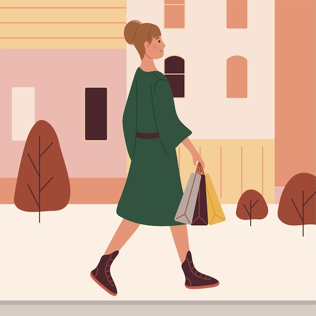 A woman in a green coat carries packages in her hand while walking down the street