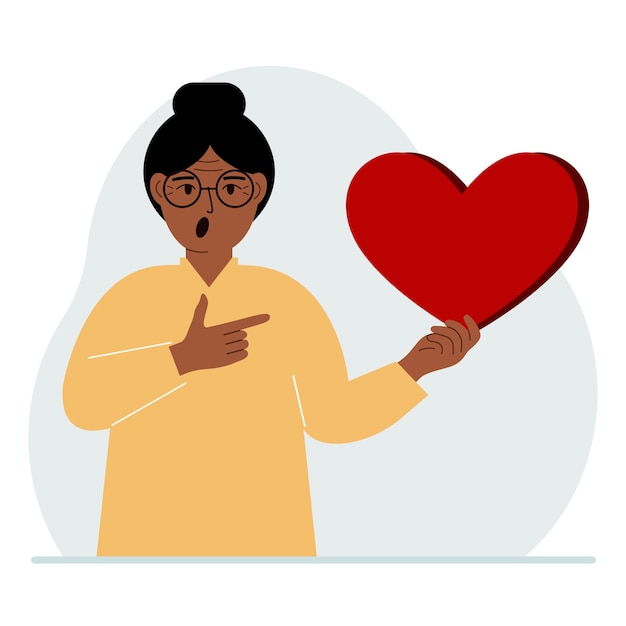 A woman holds a big red heart in his hand the concept of volunteering romantic relationship or love