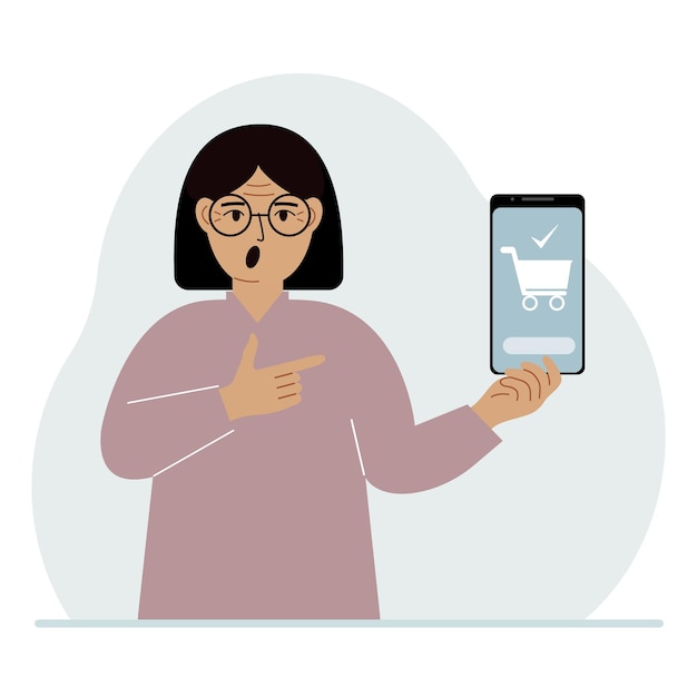 Женщина держит в руке мобильный телефон с приложением для покупок в Интернете. В телефоне есть корзина для покупок.