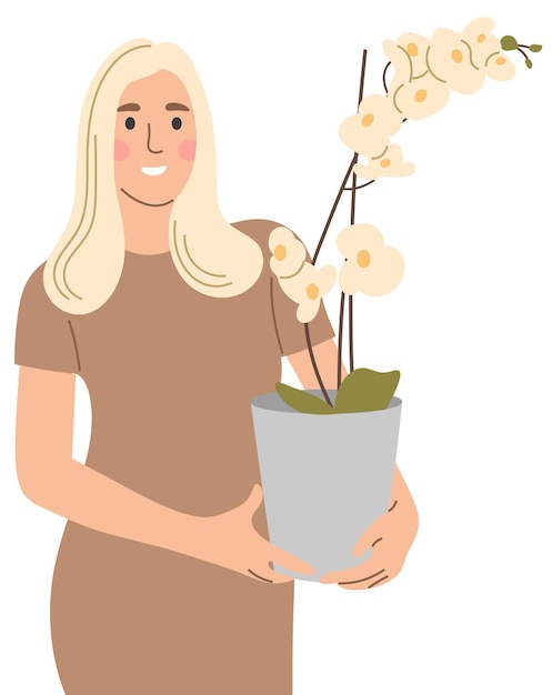 A woman holds an orchid in a pot in her hands