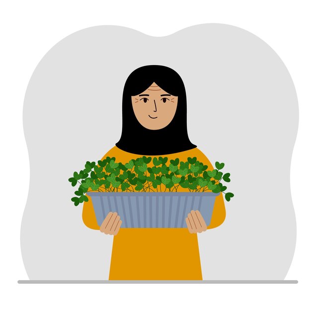 観葉植物を手に鍋を持っている女性 趣味は植物や花を育てることです