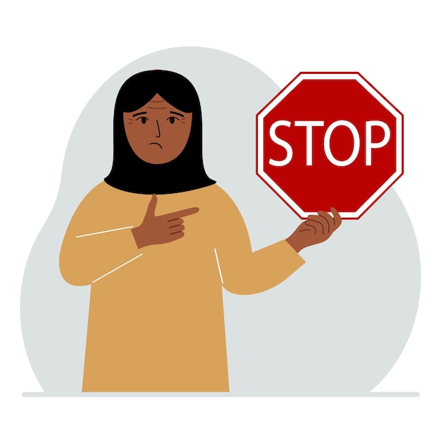 A woman holds a red stop sign in his hand