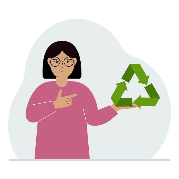 한 여성이 손에 녹색 재활용 재활용 또는 생태 기호를 들고 있습니다.