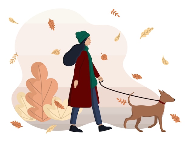 女性は犬を散歩しています。
