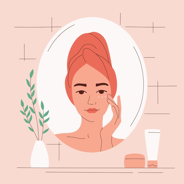woman looks in the mirror and cares for her face with cream