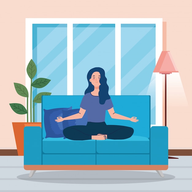 woman meditating in the living room, sitting in couch