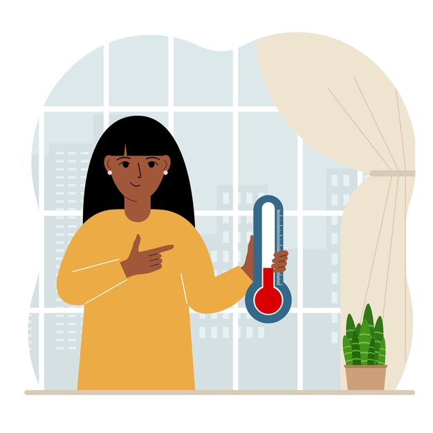Женщина у окна с прибором для измерения температуры в комнате