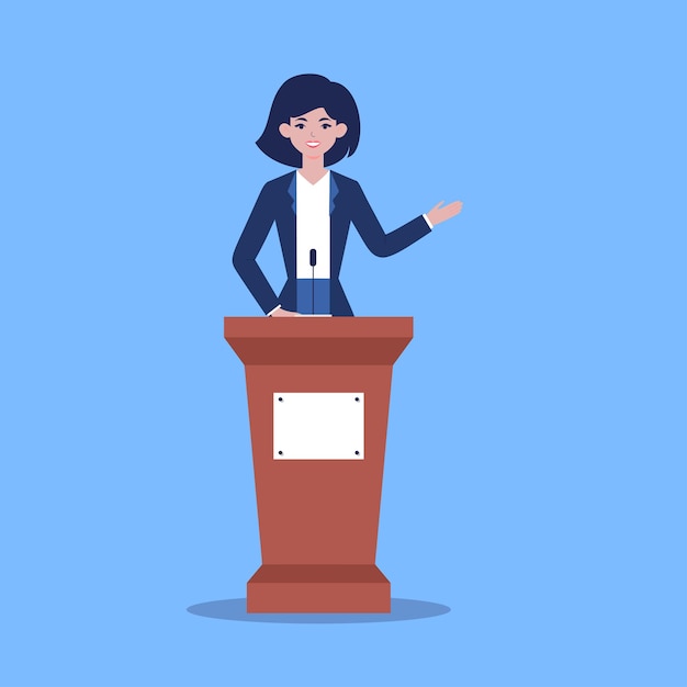 A woman politician speaks from the podium to the audience