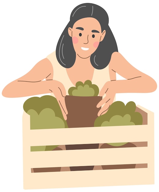 Женщина кладет комнатное растение в коробку.