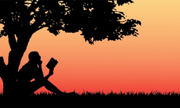 Woman reading book under the tree in park