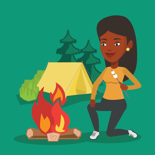 Woman roasting marshmallow over campfire.