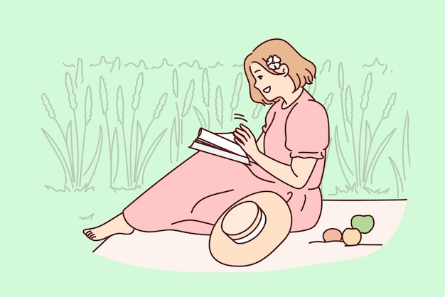 Woman sitting in field reading book