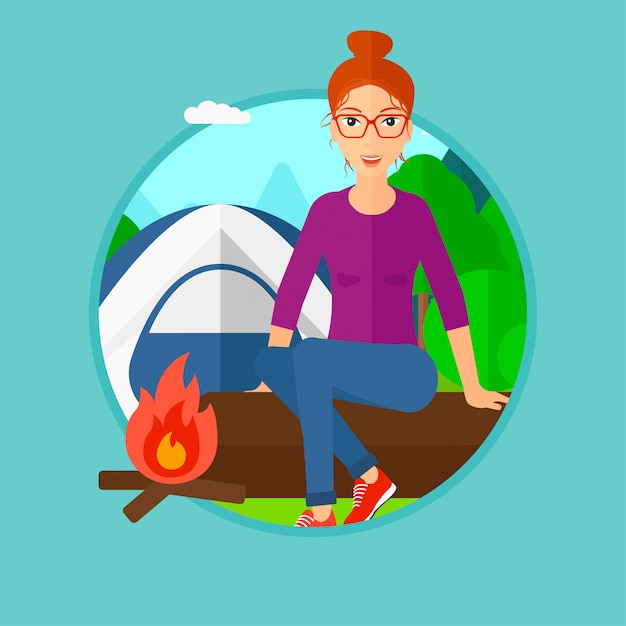 Woman sitting on log in the camping.