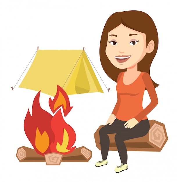 Woman sitting on log near campfire in the camping.