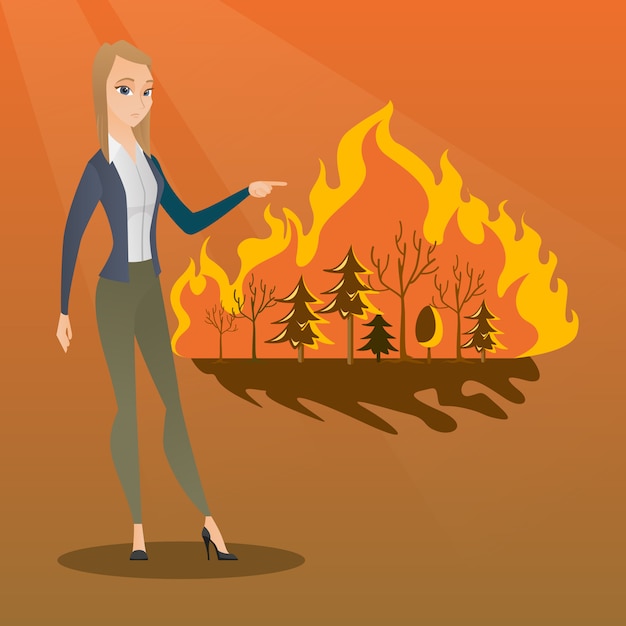 Woman standing next to wildfire.