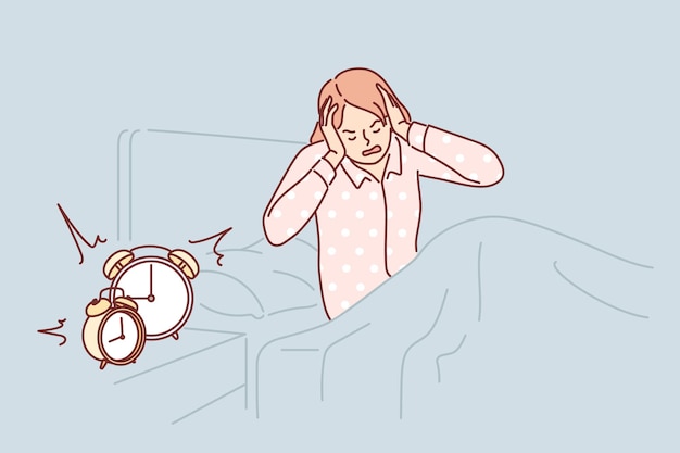 Woman wakes up with difficulty early in morning and closes ears sitting in bed near bedside table with alarm clock Girl in pajamas wakes up before work and needs extra rest due to overwork