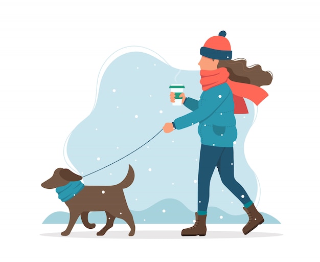 Woman walking a dog in winter.