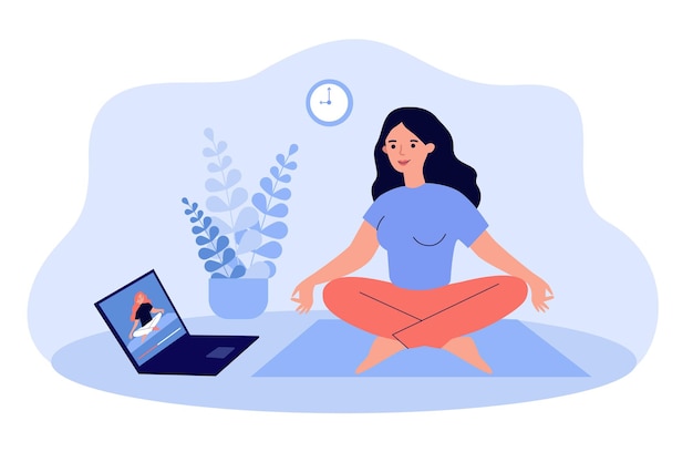 Woman watching online video yoga class on laptop and doing exercises at home