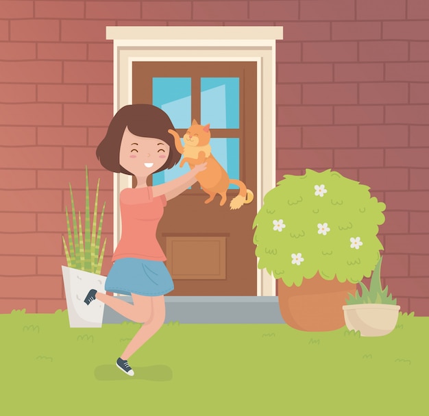 집 정원에서 귀여운 작은 고양이 마스코트와 여자
