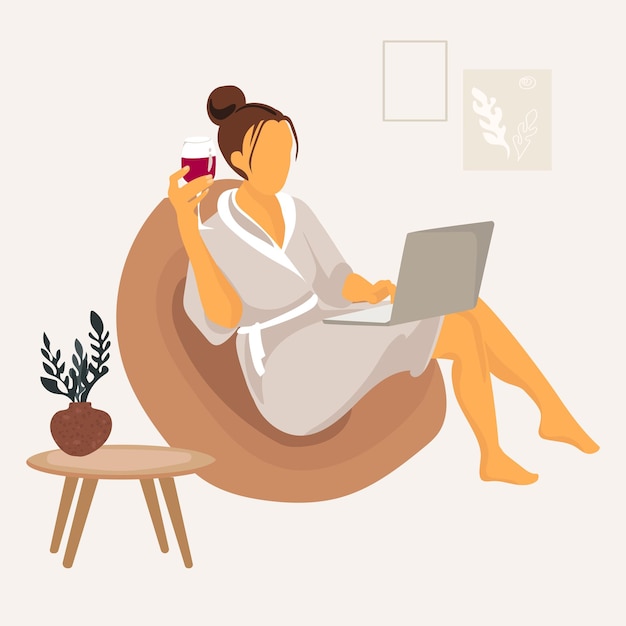 Woman with laptop sitting on the chair at home in dressing gown and with glass of wine vector