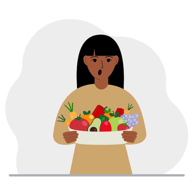 A woman with a large plate of healthy organic food vegetables and fruits The concept of healthy food healthy lifestyle vegetarianism agriculture