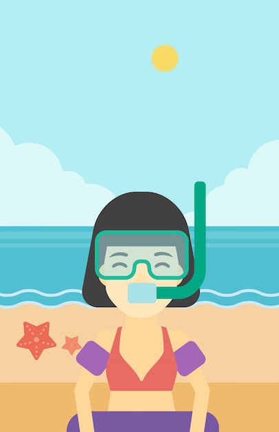 Donna con attrezzatura per lo snorkeling sulla spiaggia.