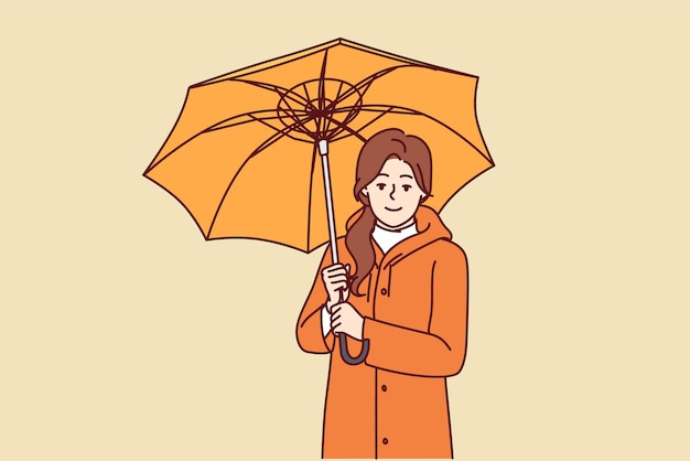 우산을 가진 여자는 가을 산책에 비에 젖지 않도록 오일클로스 코트를 입고 있다 행복한 소녀는 우산을 들고 비가 오는 날씨에 산책을 제안하는 화면을 보고 있다