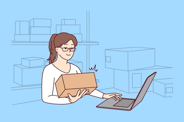 Woman working on laptop at warehouse