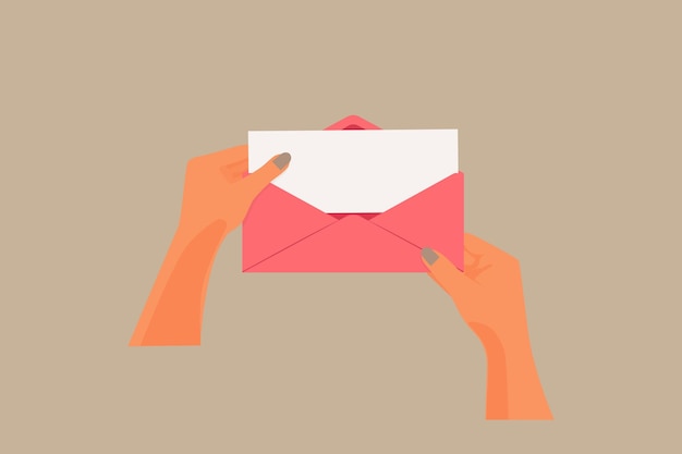 womans hands holding an open pink envelope
