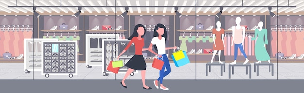 women carrying shopping bags girls couple having fun walking together holiday big sale concept modern boutique fashion shop exterior  full length horizontal banner