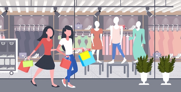 women carrying shopping bags girls couple having fun walking together holiday big sale concept modern boutique fashion shop exterior  full length horizontal