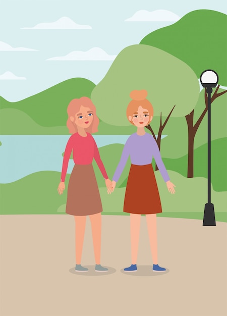 Women holding hands at park