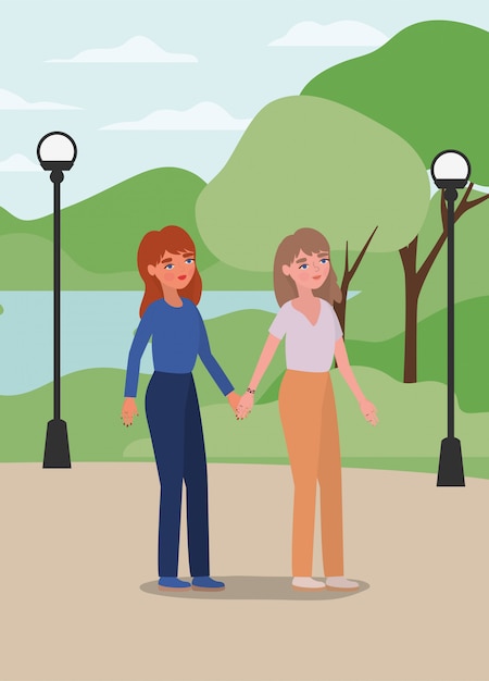 Women holding hands at park 