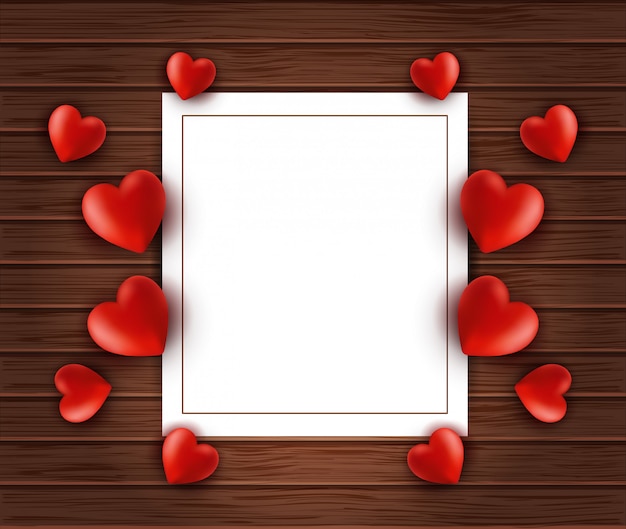 Wood background with white paper frame and hearts