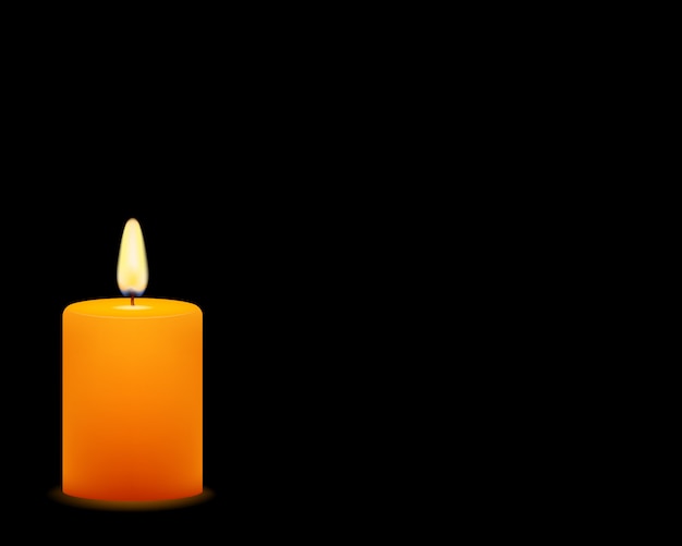 Of yellow candle on black background