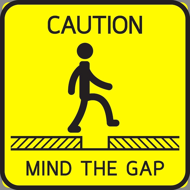 A yellow sign that says'caution mind the gap'on it