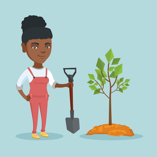 Young african-american woman planting a tree.