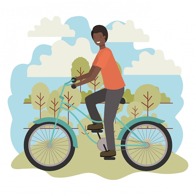 Young black man in bicycle in the park