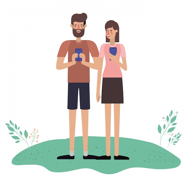 Giovane coppia utilizzando smartphone in erba