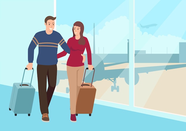 Young couple walking with luggage at the airport